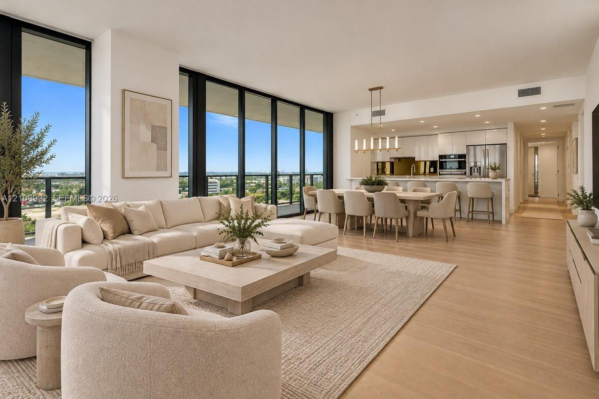 Open-concept living space featuring floor-to-ceiling windows, wood-finish flooring, recessed lighting, and a modern kitchen with built-in stainless st