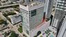 High-rise concrete structure featuring extensive glazing, tiered architectural design, and a multi-level podium