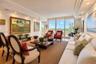 Living area featuring floor-to-ceiling glass, recessed lighting, crown molding, wood-finish flooring, and a sliding door to the exterior