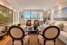Living area featuring floor-to-ceiling glass sliding doors, wood-finish flooring, recessed lighting, and crown molding