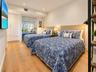 Wood-finish flooring, recessed lighting, floor-to-ceiling built-in cabinetry, and a large sliding glass door