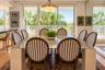 Dining area featuring floor-to-ceiling glass sliding doors, wood-finish flooring, a tiered metal pendant light fixture, and mirrored wall paneling