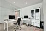 Polished concrete flooring, floor-to-ceiling glass wall partition, and recessed ceiling lighting