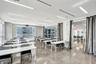 Open-concept room featuring polished concrete flooring, linear recessed lighting, floor-to-ceiling glass windows, and a glass-enclosed partitioned spa