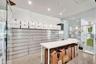 Industrial-style space featuring polished concrete flooring, recessed ceiling lighting, wall-to-wall integrated metal cabinetry, and full-height glass