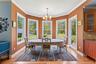 Dining area featuring plenty of natural light, a chandelier, light wood-style flooring, and crown molding