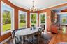 Dining area with a chandelier, baseboards, crown molding, and light wood-type flooring