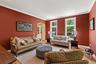 Living area featuring arched walkways, crown molding, light wood finished floors, baseboards, and recessed lighting