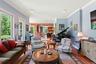 Living area featuring plenty of natural light, wood finished floors, baseboards, recessed lighting, and crown molding