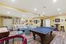 Game room with recessed lighting, wood finished floors, ornamental molding, and baseboards