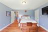 Bedroom with light wood-type flooring and baseboards