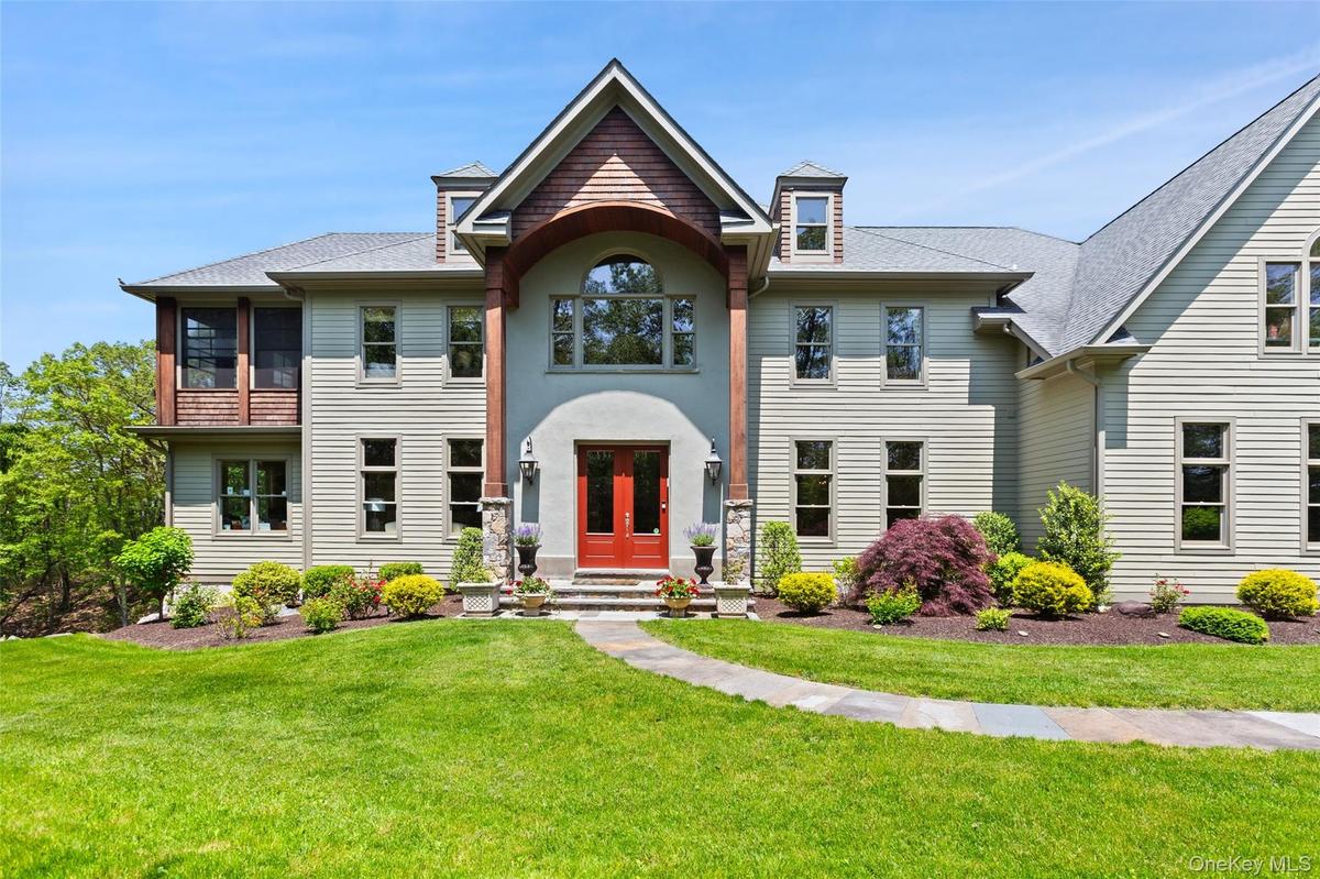 View of front of house with a front lawn, roof with shingles, and french doors