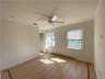 Empty room with light hardwood / wood-style flooring, a baseboard heating unit, crown molding, and ceiling fan
