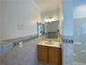 Bathroom featuring vanity, tile patterned flooring, tile walls, and crown molding