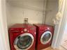 Laundry area with tile patterned floors and washer and dryer