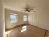 Unfurnished bedroom featuring ceiling fan, light hardwood / wood-style flooring, baseboard heating, and crown molding