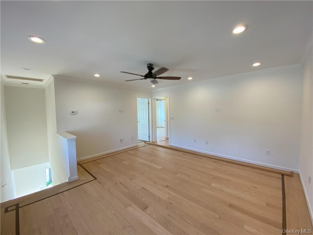 Unfurnished room featuring light hardwood / wood-style floors, crown molding, and ceiling fan