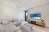 Minimalist interior space featuring recessed ceiling lighting, wood-finish flooring, a tall narrow glass door with a black frame, and a wall-mounted w