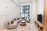 Floor-to-ceiling windows, sliding glass door access to balcony, neutral wall finish, and light-toned hard-surface flooring