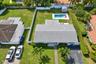 Expansive backyard featuring an inground swimming pool, concrete patio, perimeter privacy fencing, and mature landscaping