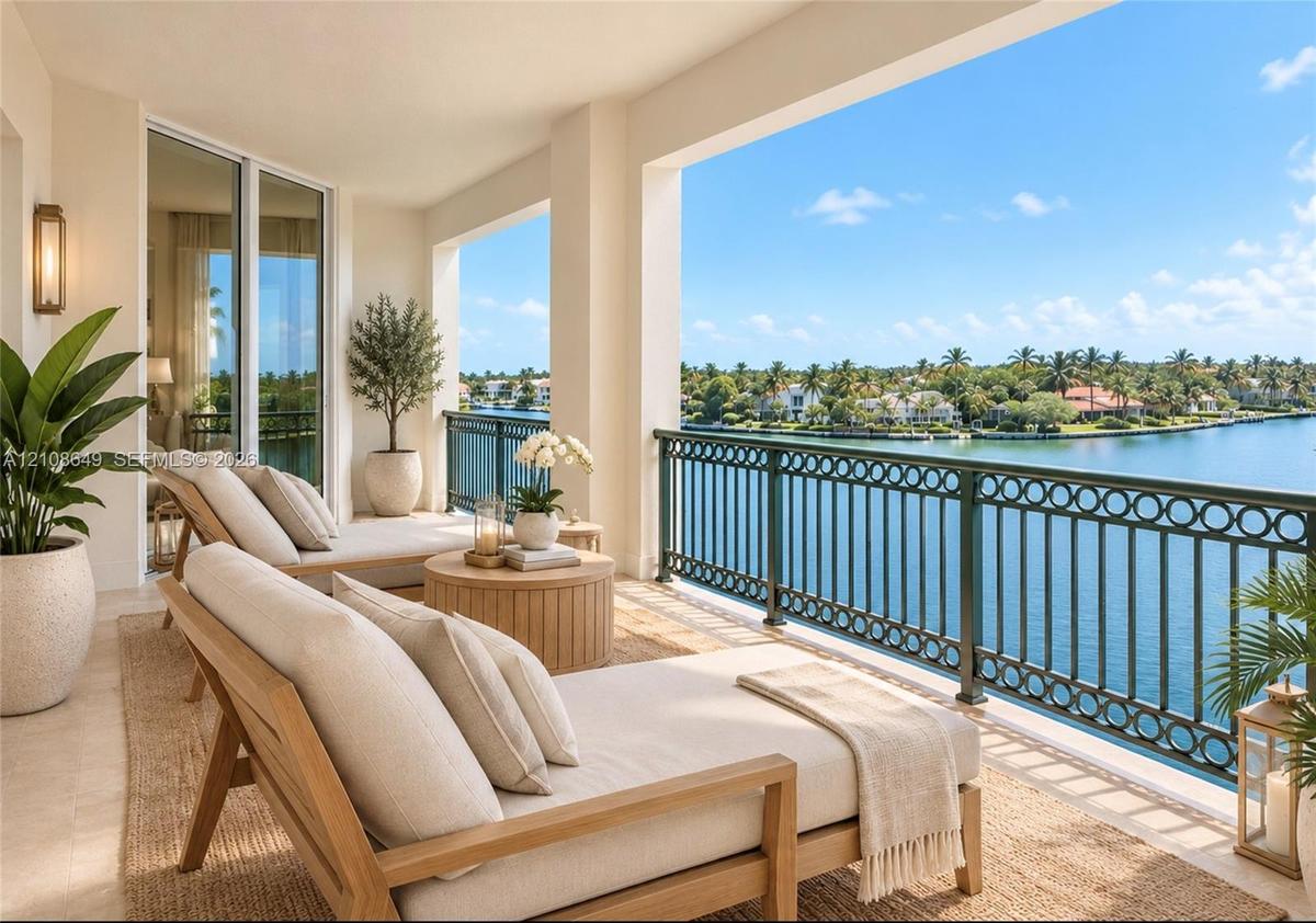 Covered balcony featuring stone-finish flooring, custom metal railing, and direct water exposure
