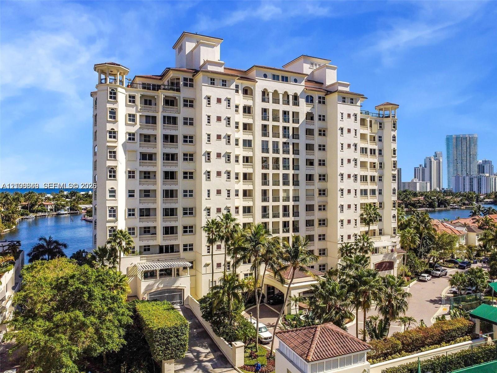 Mid-rise waterfront building architectural detailing, clay tile roof, and porte-cochère entry