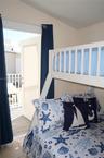 Exterior door providing access to a balcony with white metal railings