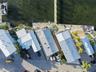 Waterfront property featuring metal roofing, a private dock, and paved hardscaping