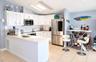Kitchen featuring white cabinetry, tile countertops, stainless steel appliances, and tile flooring