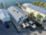 Waterfront property featuring a metal roof, dual skylights, paved exterior grounds, and a private dock