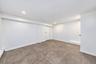 Interior space featuring neutral wall tones, large-format tile flooring, and recessed ceiling lighting