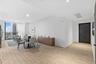 Open-concept area featuring wood-finish tile flooring, recessed ceiling lighting, and floor-to-ceiling windows