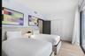 Wood-finish flooring, full-height built-in storage cabinetry, and floor-to-ceiling glass paneling