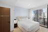 Floor-to-ceiling windows, wood-finish flooring, and a solid wood-finish door with matte black hardware