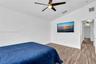 Vaulted ceilings, wood-finish flooring, and a modern ceiling fan