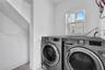Laundry area featuring a dedicated window with natural light and a recessed nook