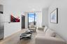 Living area featuring floor-to-ceiling windows, wood-finish flooring, and recessed ceiling lighting