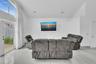Vaulted ceiling featuring recessed lighting, large-format tile flooring, and floor-to-ceiling windows with glass exterior door
