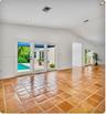 Living area featuring vaulted ceilings, French doors providing outdoor access