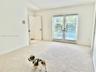 Primary bedroom with high ceiling ceiling, and dual-pane glass French doors to pool.
