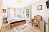 Very Large and Bright Primary Bedroom, featuring Hardwood Flooring and 2 large windows. Located on the 1st floor!