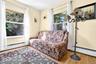 Sunny 2nd Bedroom on the 1st Floor, featuring hardwood flooring and 2 large windows.