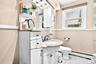 Large Bathroom on the 1st Floor, featuring vanity with extra drawers, shower stall with beautiful ceramic tiling and  window.