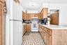 Very large kitchen with penisula, refrigerator, stove/oven and microwave.