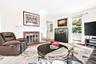 Center view of the Sunny, Huge Living Room, featuring a beautiful woodburning Fireplace.