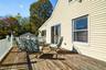 View of the Expansive Deck (with carport underneath) with glass sliding doors to the Living Room and Kitchen.