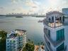 High-rise architecture featuring expansive rooftop terraces, glass-railing balconies, floor-to-ceiling windows, and waterfront positioning overlooking