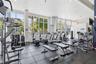 Fitness center featuring floor-to-ceiling windows, rubberized flooring, and recessed lighting