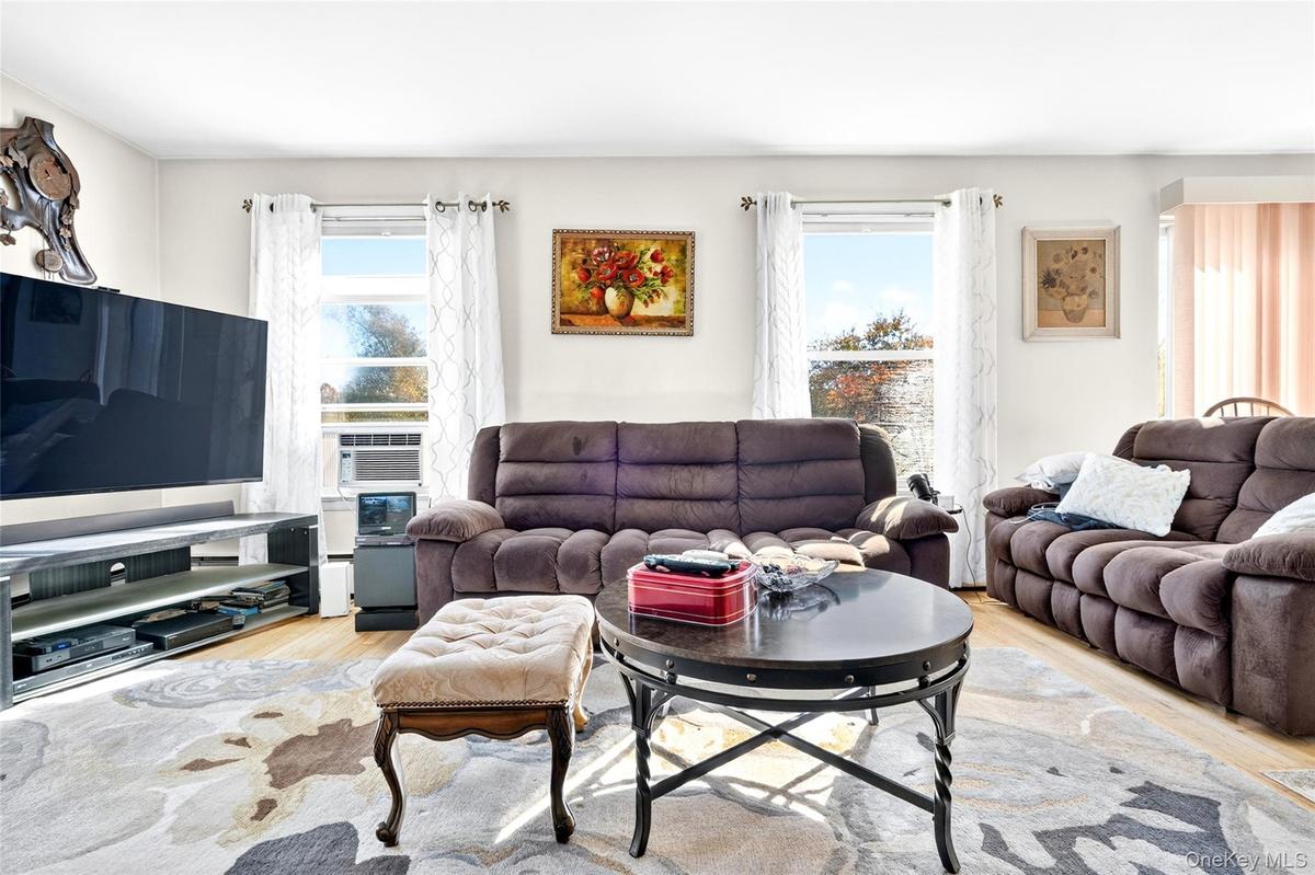 Another view of the very bright, oversized, warm and inviting Living Room with hardwood flooring
