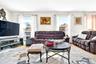 Another view of the very bright, oversized, warm and inviting Living Room with hardwood flooring